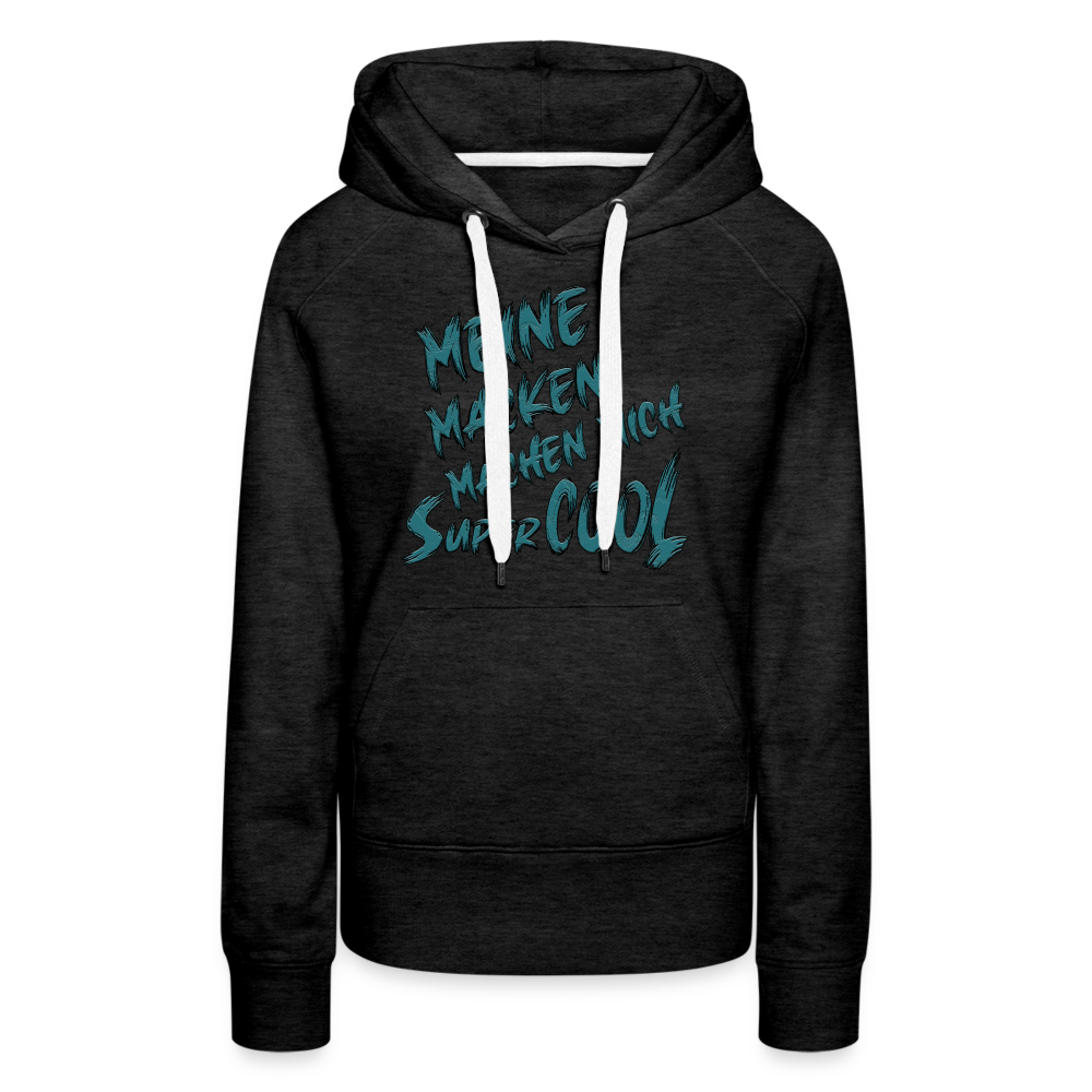 Anthrazit farbener Streetwear Hoodie für Frauen mit dem Spruch auf den Brust „Meine Macken machen mich super cool“. Stilvolle Typografie, lustige Sprüche, mit kontrastfarbigen Kapuzenband und praktischer Kängurutasche. Perfekt für Alltag und Freizeit.