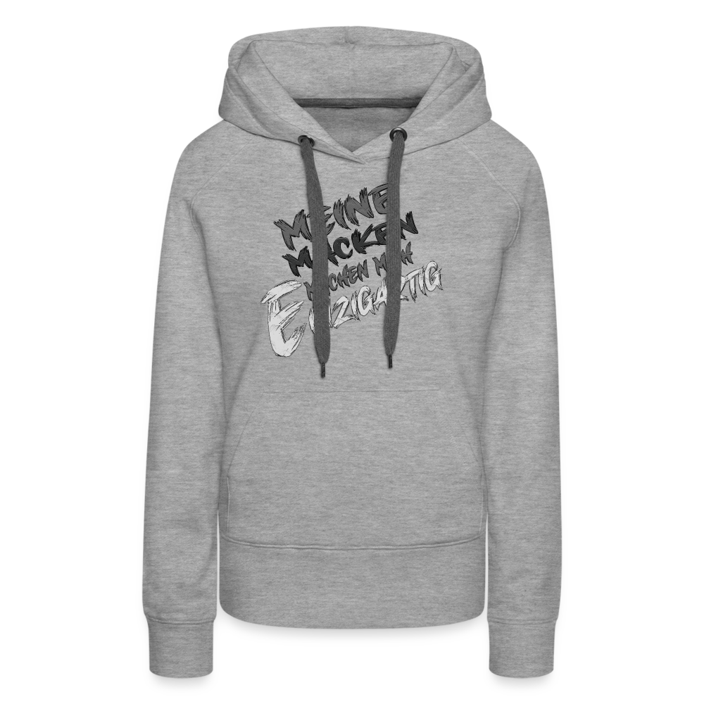 Grau meliert Streetwear Hoodie für Frauen mit dem humorvollen Statement „Meine Macken machen mich einzigartig“. Modernes Design mit weißer und schwarzer Schrift in kreativer Typografie auf der Vorderseite, kontrastfarbene Kapuzenbänder und praktische Kängurutasche. Perfekt für einen lässigen Look.